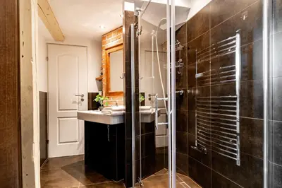 a bathroom with a sink and a shower at be HAPPY Apartments & Breakfast in Kraków
