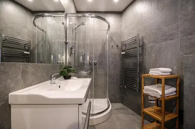 a bathroom with a sink and a shower at be HAPPY Apartments & Breakfast in Kraków