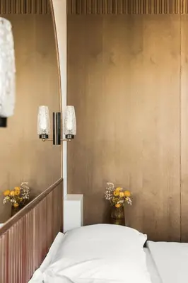 a bedroom with a white bed and a mirror at Angelus Apartments in Kraków