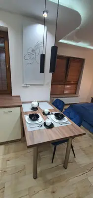 a wooden table in a room with a kitchen at PARK GRZEGÓRZKI in Kraków