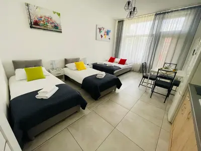 a room with two beds and a couch in it at Gladiator Noclegi Zator II in Zator