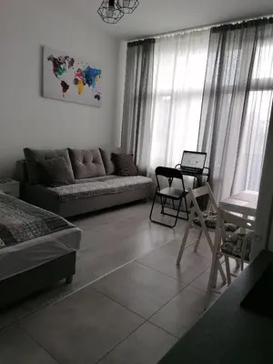 a living room with a couch and a table with a laptop at Gladiator Noclegi Zator II in Zator