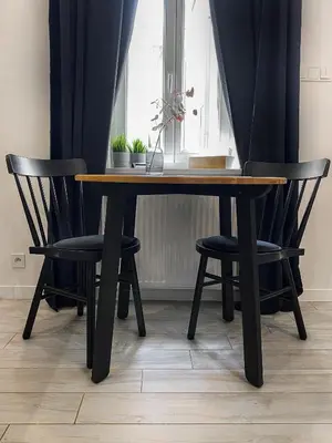 a dining room table with two chairs and a window at Beautiful studio for couples with Air Conditioning - Old Town & Main station in Kraków