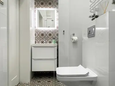 a white bathroom with a toilet and a mirror at Beautiful studio for couples with Air Conditioning - Old Town & Main station in Kraków