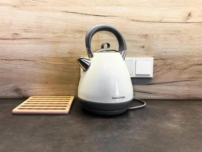 a tea kettle sitting on a counter next to a lightswitch at Beautiful studio for couples with Air Conditioning - Old Town & Main station in Kraków