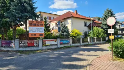 a street with signs in front of a house at Apartament DeLuxe 2 in Oświęcim