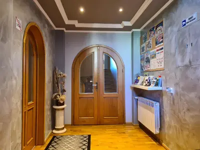 a hallway with a wooden door in a house at Apartament DeLuxe 2 in Oświęcim