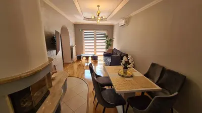 a living room with a table and chairs at Apartament DeLuxe 2 in Oświęcim