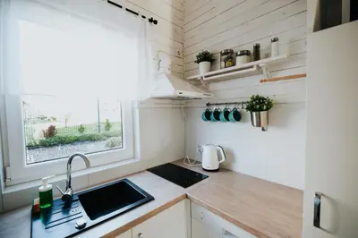 a small kitchen with a sink and a window at Domki Beskidowelove Gierałtowiczki A in Zator