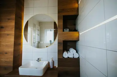 a bathroom with a sink and a mirror at Domki Beskidowelove Gierałtowiczki A in Zator