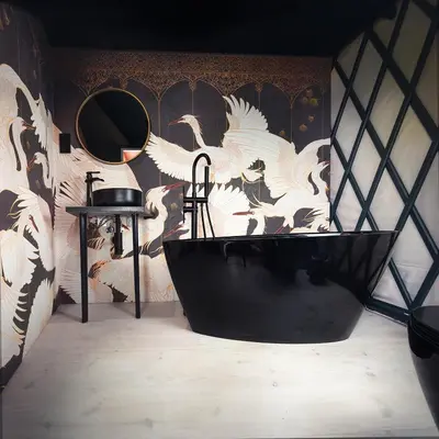 a bathroom with a black tub and a wall with birds at LushHills - Stylowa i Naturalna Jurta in Regulice