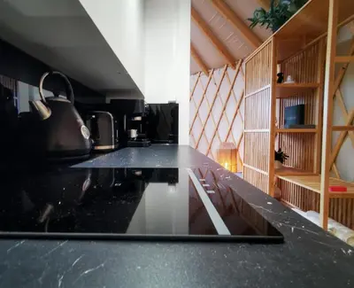 a laptop sitting on a counter in a kitchen at LushHills - Stylowa i Naturalna Jurta in Regulice