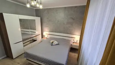 a bedroom with a bed with a pillow on it at Apartament DeLuxe 3 in Oświęcim