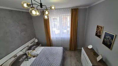 a bedroom with a bed and a window at Apartament DeLuxe 3 in Oświęcim