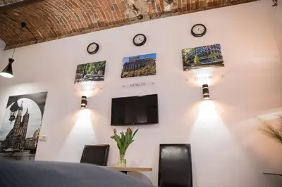 a dining room with clocks on the wall at Rose - Apartamenty Kleparskie in Kraków