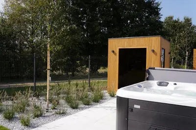 a small wooden shed with a sink in a yard at Apartamenty na Dworskiej - BLISKO ENERGYLANDIA ZATORLAND in Spytkowice
