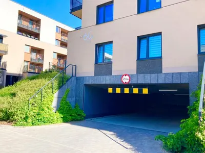 a parking garage in front of a building at Apartament Łagiewniki in Kraków