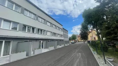 an empty street in front of a building at Aparthotel WADOWICE & Hostel GENERY in Wadowice
