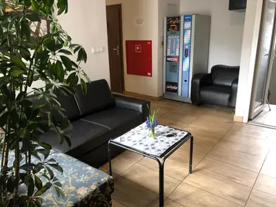 a living room with a couch and a coffee table at Aparthotel WADOWICE & Hostel GENERY in Wadowice