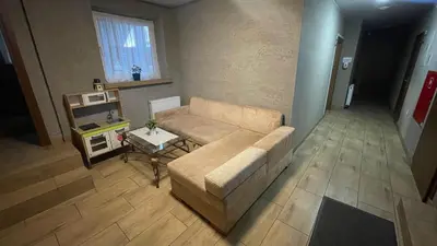 a living room with a couch and a table at Aparthotel WADOWICE & Hostel GENERY in Wadowice