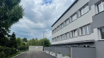 an empty parking lot next to a building at Aparthotel WADOWICE & Hostel GENERY in Wadowice