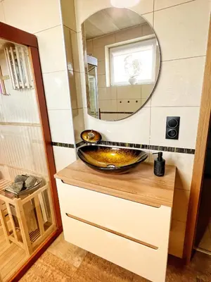 a bathroom with a sink and a mirror at Apartament Premium Skawina in Skawina