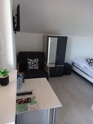 a living room with a couch and a bed at Ojcowski Las in Biały Kościół
