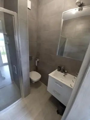 a bathroom with a toilet and a sink and a mirror at Ojcowski Las in Biały Kościół