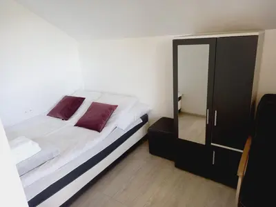 a bedroom with a bed and a mirror at Ojcowski Las in Biały Kościół