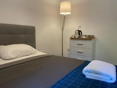 a bedroom with a bed with two towels on it at Milla Apartments in Kraków