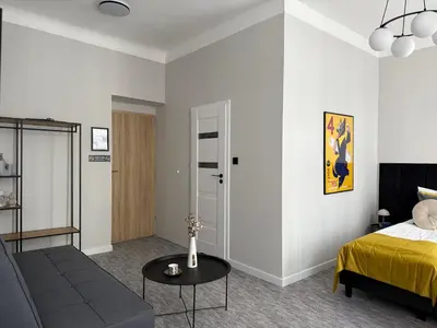 a living room with a bed and a couch at Milla Apartments in Kraków