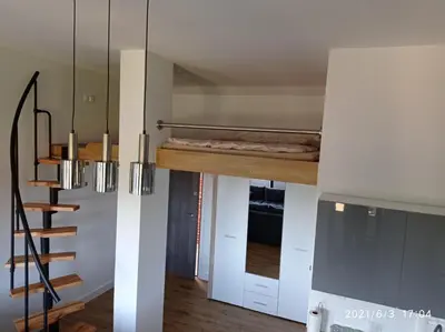 a room with a bed and a staircase in it at Apartamenty Kasztanowa Zator in Zator