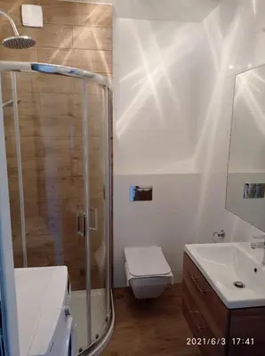 a bathroom with a shower and a toilet and a sink at Apartamenty Kasztanowa Zator in Zator