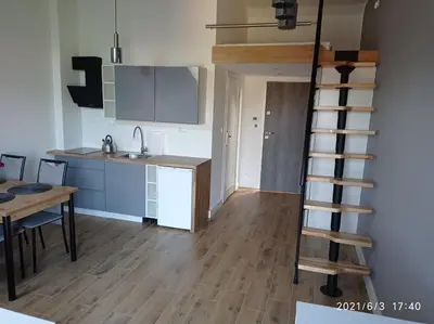 a kitchen and a ladder in a small room at Apartamenty Kasztanowa Zator in Zator