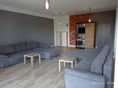 a living room with two couches and two tables at Apartamenty Kasztanowa Zator in Zator