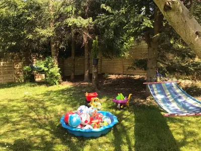 a bowl full of toys in a yard with a hammock at Domek Damianki - cały dom in Zawoja