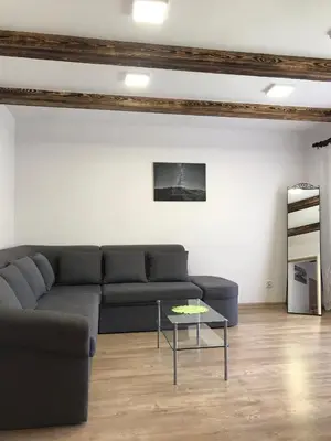 a living room with a couch and a table at Domek Damianki - cały dom in Zawoja