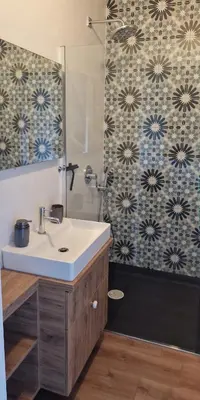 a bathroom with a sink and a shower at Apartamenty Parkowe D9 z garażem in Oświęcim