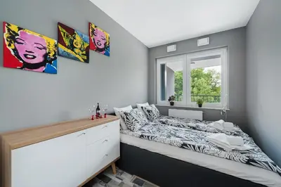 a bedroom with a bed and a window at Barska 69 Taras 360 in Kraków