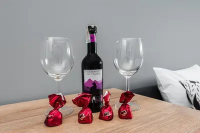 a bottle of wine and two wine glasses on a table at Barska 69 Taras 360 in Kraków