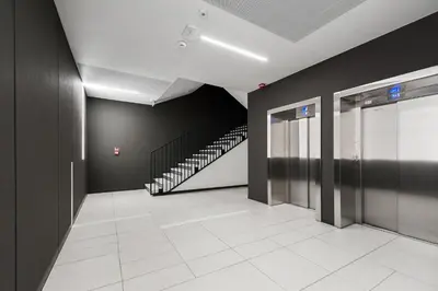 a hallway with a staircase in a building at Barska 69 Taras 360 in Kraków