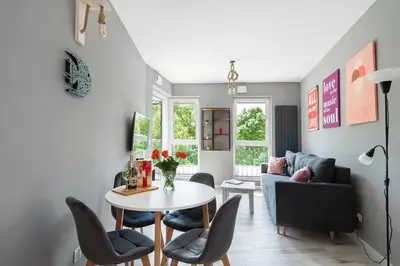 a living room with a table and chairs and a couch at Barska 69 Taras 360 in Kraków