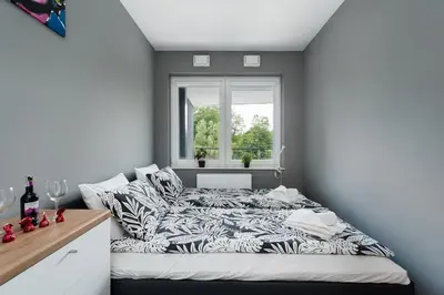 a bed in a room with a window at Barska 69 Taras 360 in Kraków