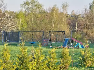 a park with playground equipment in the grass at Gosp. Agroturystyczne Stary Gaj in Żerkowice