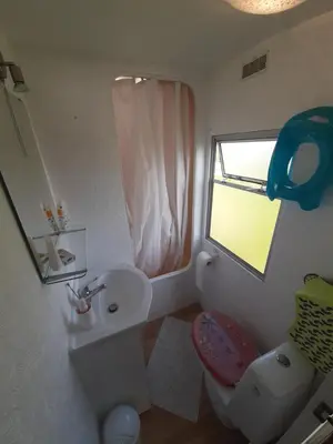 a bathroom with a sink and a toilet and a window at Gosp. Agroturystyczne Stary Gaj in Żerkowice
