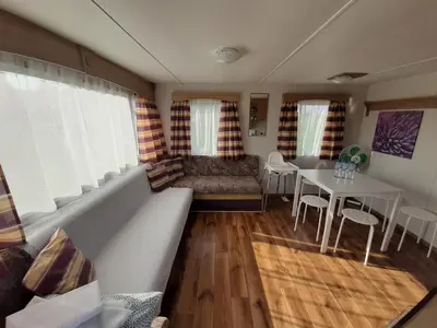 a living room with a couch and a table at Gosp. Agroturystyczne Stary Gaj in Żerkowice
