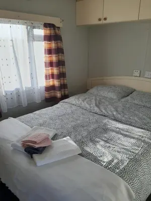 a bedroom with a bed with two towels on it at Gosp. Agroturystyczne Stary Gaj in Żerkowice