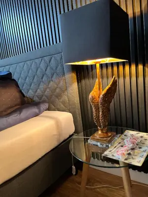 a lamp on a table next to a bed at Jacuzzi Rakowicka Top Apartments in Kraków