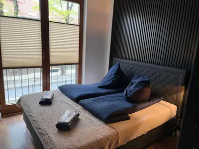 a bed with two bags on top of it at Jacuzzi Rakowicka Top Apartments in Kraków