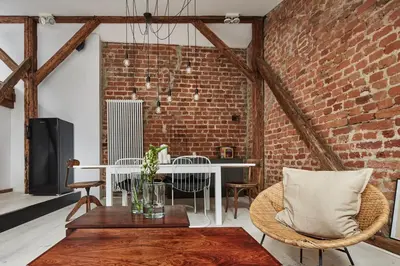 a room with a brick wall and a table and chairs at OLD NEW - Prime Location on Main Square in Kraków